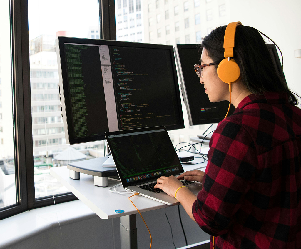 Professional woman working on a laptop in a bright office environment